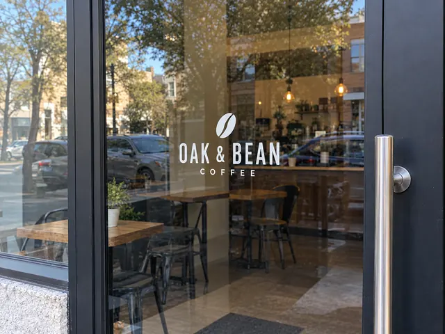 Small white cafe wordmark applied as cut vinyl on a glass door